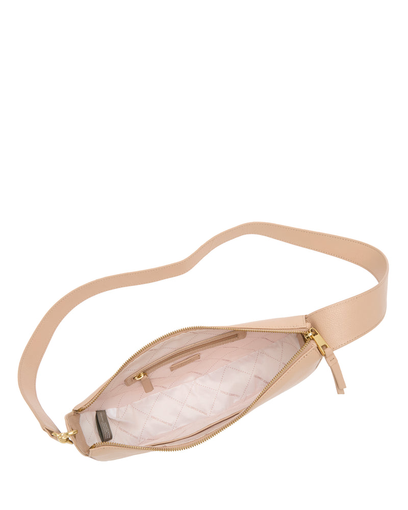 The Vince Camuto Orlie Crossbody Bag in beige leather features a gold zipper and opens to reveal a light pink quilted interior with inner pockets. Displayed on a white background, this accessory combines style and function for any occasion.