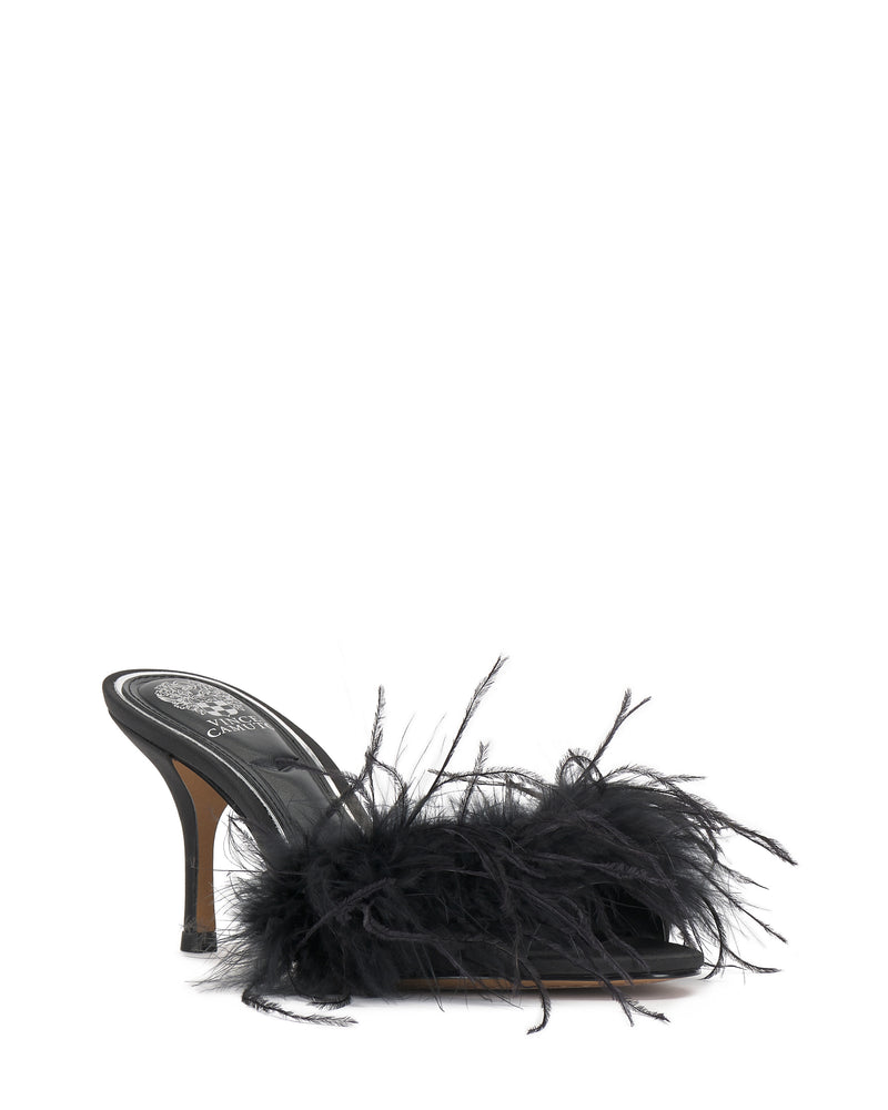 The Paelly Feather Mule by Vince Camuto features a black open toe, a slim high heel, and dramatic black feathers adorning the front strap.