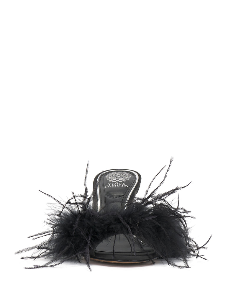 The Paelly Feather Mule by Vince Camuto is a black open-toe sandal featuring bold black feather detailing on the front strap, shown on a white background.