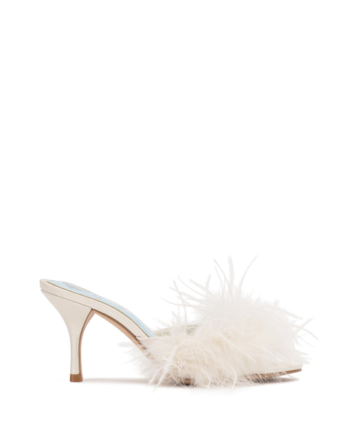 The Paelly Feather Mule by Vince Camuto is a white open-toe high heel featuring a slender heel and a fluffy feather detail across the front strap.