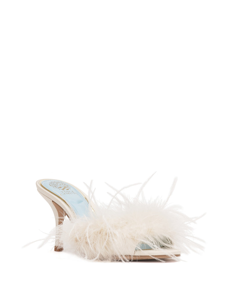 The Vince Camuto Paelly Feather Mule is a high-heeled, open-toe mule slipper with a light blue insole and a fluffy white feather trim across the front.