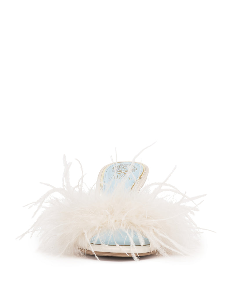 The Vince Camuto Paelly Feather Mule is a light blue open-toe sandal with a low heel and fluffy white feather trim across the top, shown from the front against a plain white background.