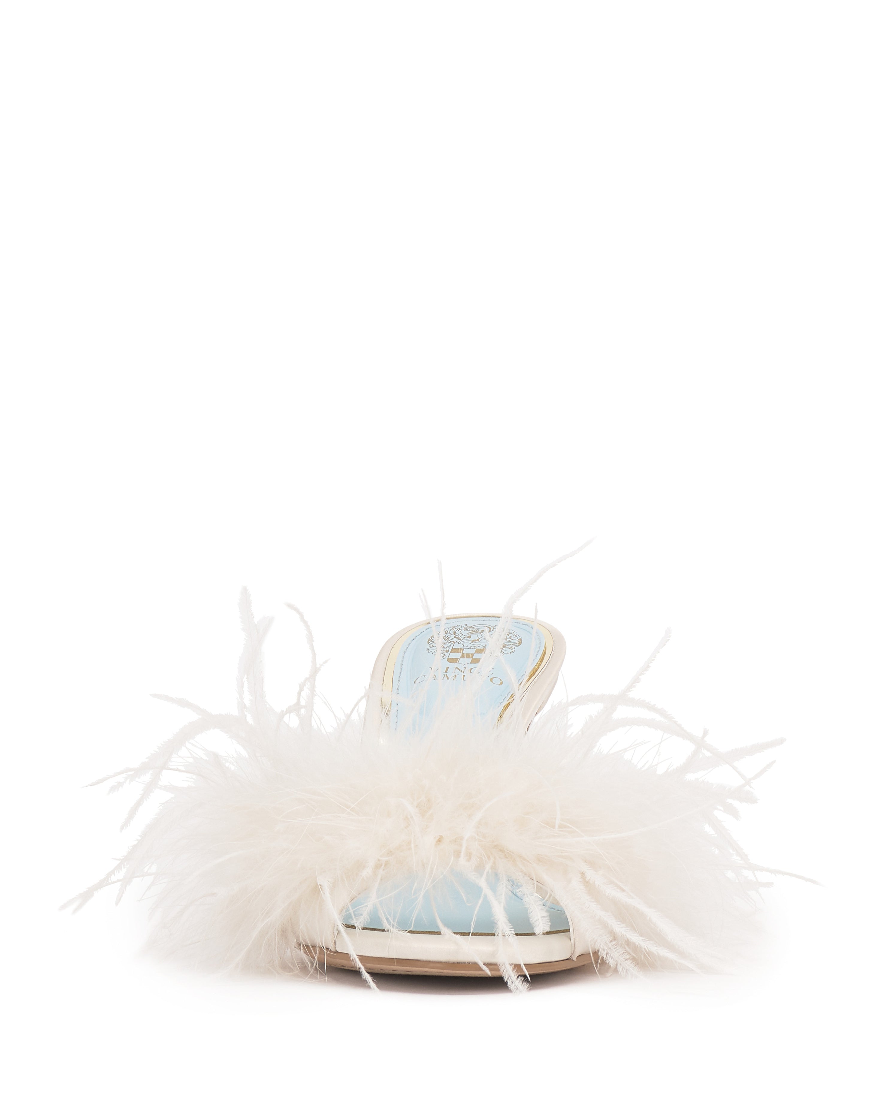 The Vince Camuto Paelly Feather Mule is a stylish light blue women's shoe with an open toe, flat heel, and fluffy white feather trim across the front, shown against a plain white background.