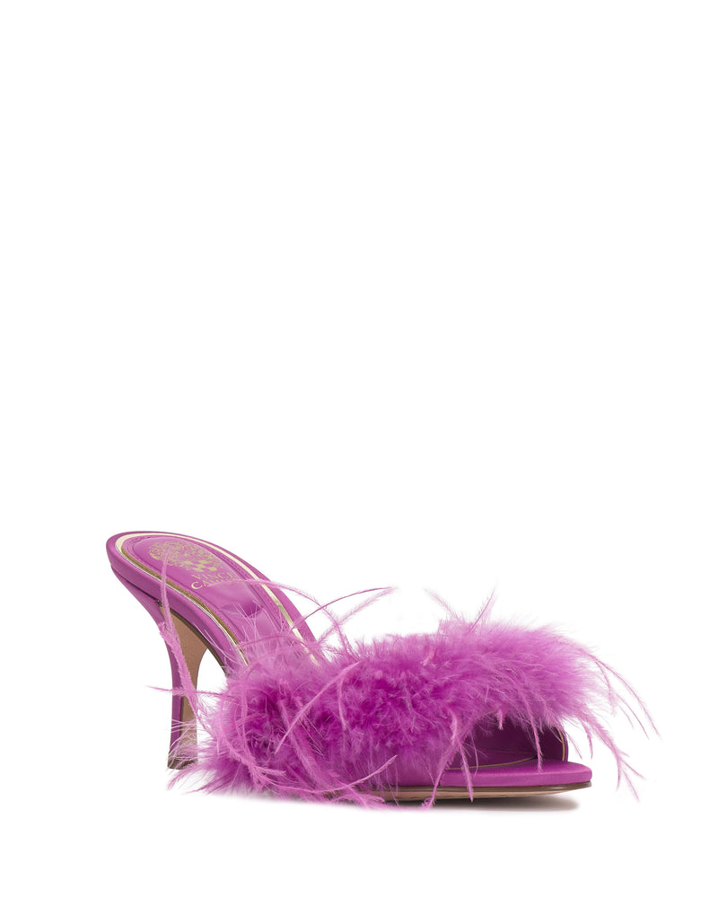 The Vince Camuto Paelly Feather Mule is a vibrant purple high-heeled open-toe shoe with a fluffy feather trim across the front, displayed on a plain white background.