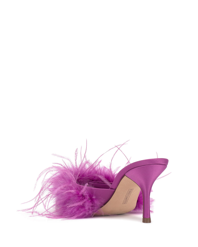 The Vince Camuto Paelly Feather Mule is a single high-heeled shoe in vibrant purple with feathered accents on the upper strap, shown from the back against a plain white background.