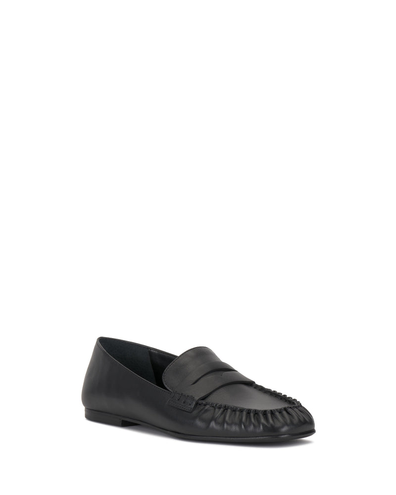 The Vince Camuto Paelyn Penny Loafer is a black leather, moccasin-style shoe with a rounded toe, low heel, and ruched front detailing, shown on a plain white background.