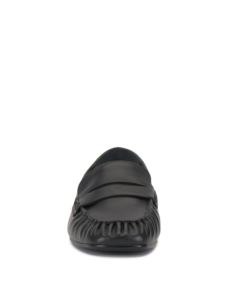 Front view of the Vince Camuto Paelyn Penny Loafer, a black leather shoe featuring moc-toe stitching, penny strap, and moccasin-inspired design, displayed against a white background.
