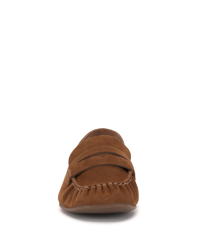 Front view of the Vince Camuto Paelyn Penny Loafer in brown suede, featuring moccasin-style stitching and a low-profile sole, displayed against a white background.