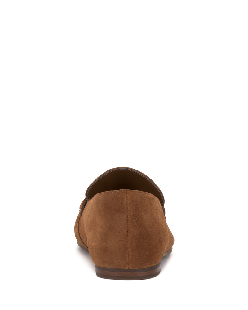 The Vince Camuto Paelyn Penny Loafer is shown from the back, highlighting the heel, part of the sole, and moccasin-inspired detailing against a white background.