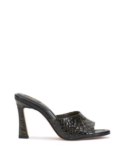 The Vince Camuto Paigely Mule is a high-heeled, open-toe minimalist mule featuring a glossy black crocodile pattern, square-based flared heel, and pillow footbed, shown against a white background.