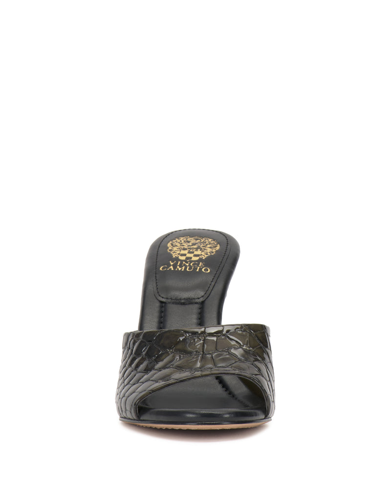 Front view of the Vince Camuto Paigely Mule in black, featuring an open toe, minimalist design with a crocodile pattern, pillow footbed for comfort, and gold Vince Camuto logo on the insole.