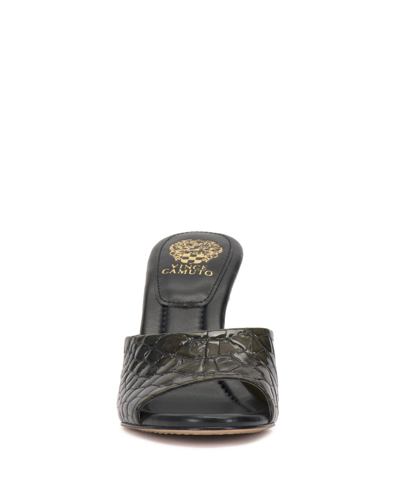 Front view of the Vince Camuto Paigely Mule—a black open-toe minimalist sandal with a crocodile-textured pattern, flared heel, and an insole featuring gold Vince Camuto branding and decorative details.