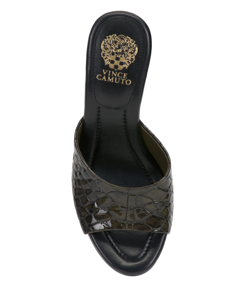 The Paigely Mule by Vince Camuto is a black open-toe sandal with a crocodile texture, wide front strap, flared heel, and gold Vince Camuto branding on the insole.