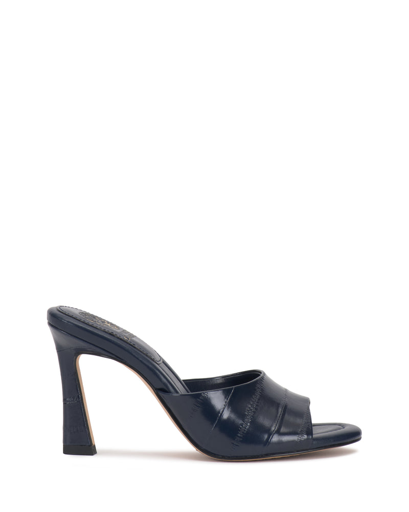 The Paigely Mule by Vince Camuto, featuring a minimalist design in navy blue with a wide strap, open toe, and flared heel, is displayed against a plain white background.