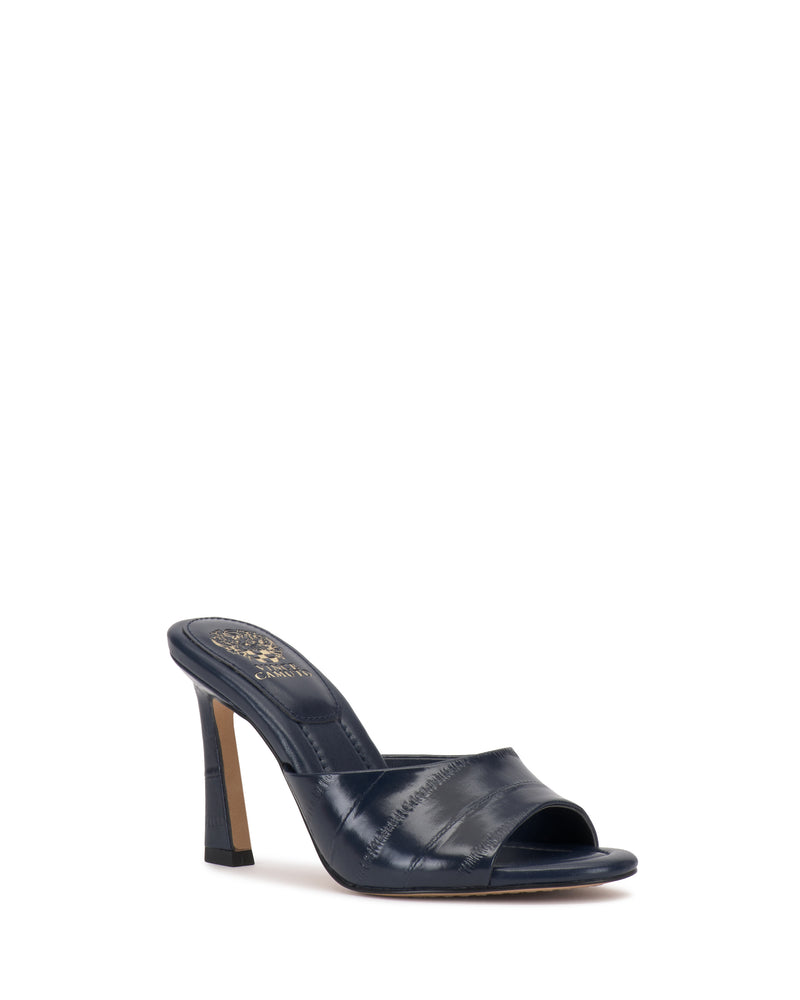 The Vince Camuto Paigely Mule is a single black minimalist sandal featuring a flared high heel, open toe, and wide leather strap, shown on a white background.