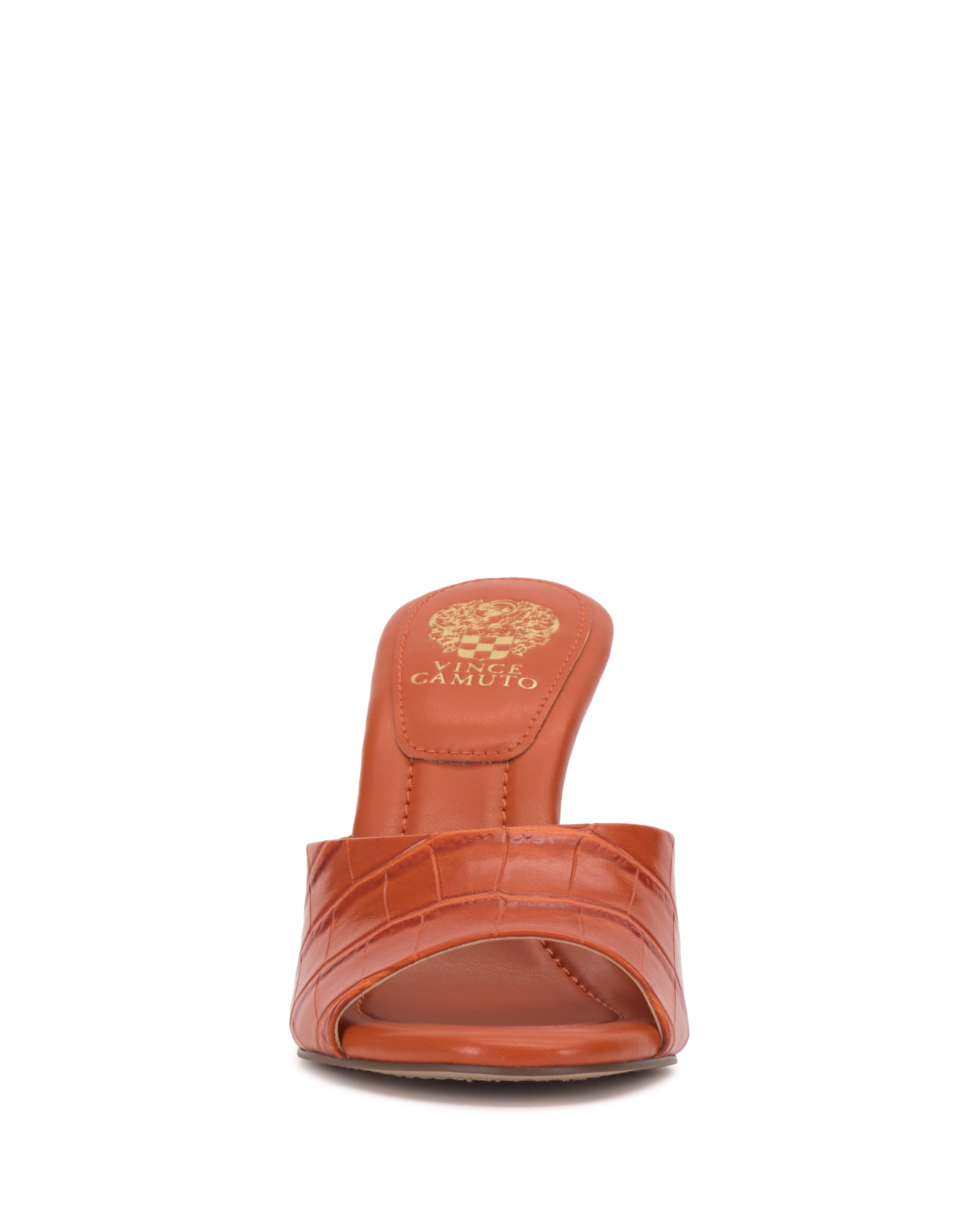 Front view of the Paigely Mule by Vince Camuto, a brown open-toe heeled sandal featuring a textured pattern, flared heel, and gold brand logo on the insole.