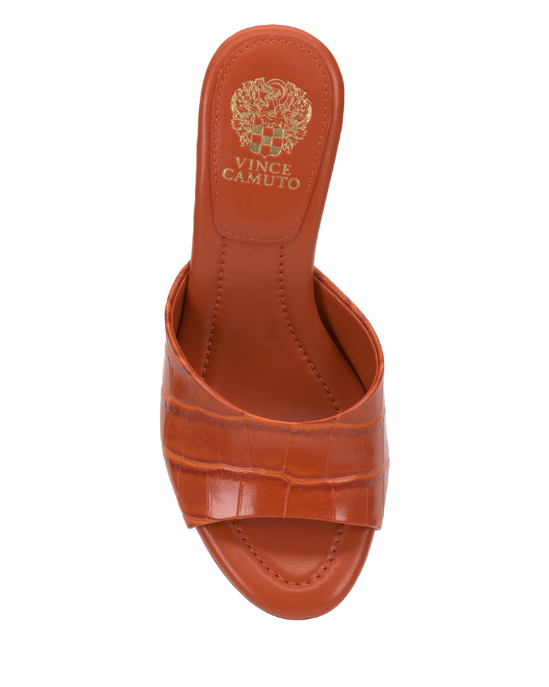 A top view of the Vince Camuto Paigely Mule—an orange, open-toe slide sandal featuring a wide crocodile-textured strap, pillow footbed for comfort, and a gold Vince Camuto logo on the insole.