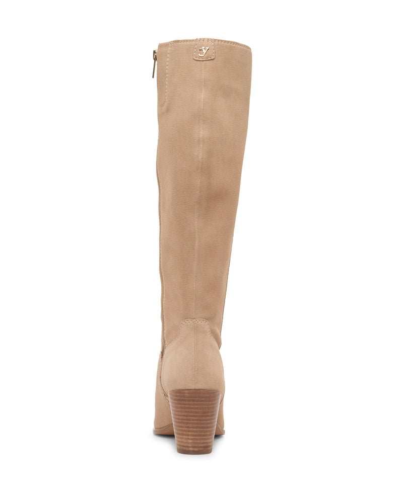 The Vince Camuto Pamlia Wide Calf Knee High Boot is a tan suede boot with a chunky block heel, western-inspired details, zipper closure, and subtle stitching, shown from the back.