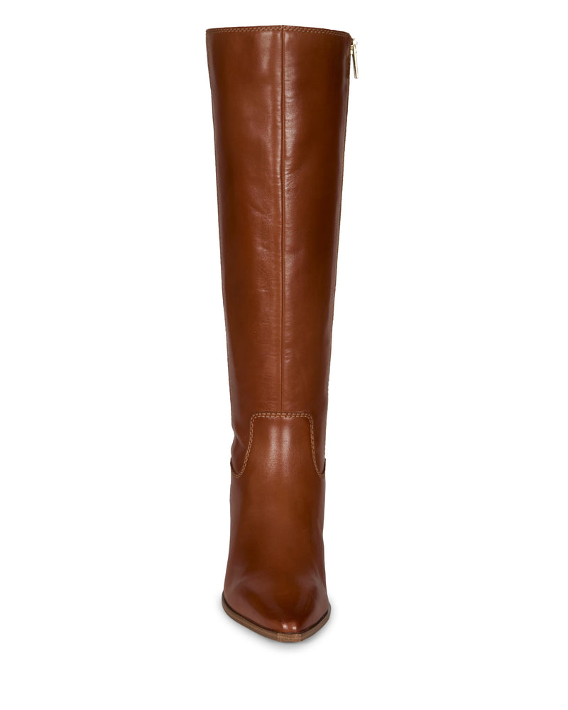 The Pamlia Knee High Boot by Vince Camuto features a tall, brown leather design with a pointed toe and side zipper, combining classic style with a chic western-inspired silhouette.