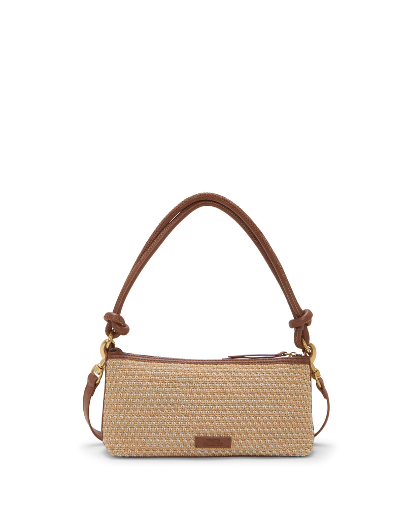 The Paula Crossbody Bag by Vince Camuto is a small rectangular beige woven canvas bag with brown leather trim, a short curved shoulder strap, and gold hardware, shown on a white background.