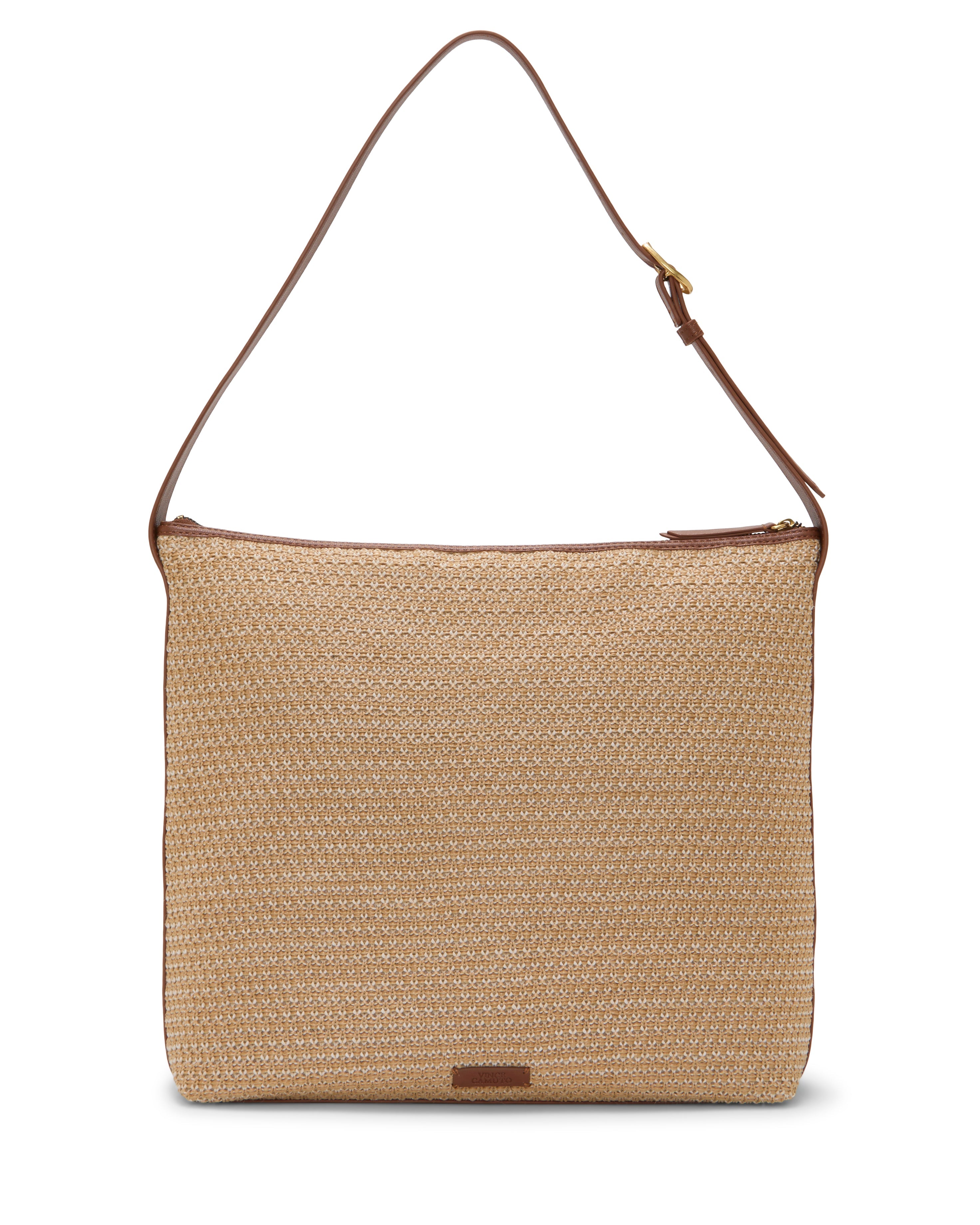 The Paula Shoulder Bag by Vince Camuto is a rectangular woven straw bag with brown adjustable leather strap and trim, plus a small leather patch. Its zip-top closure keeps your summer essentials secure and stylish.