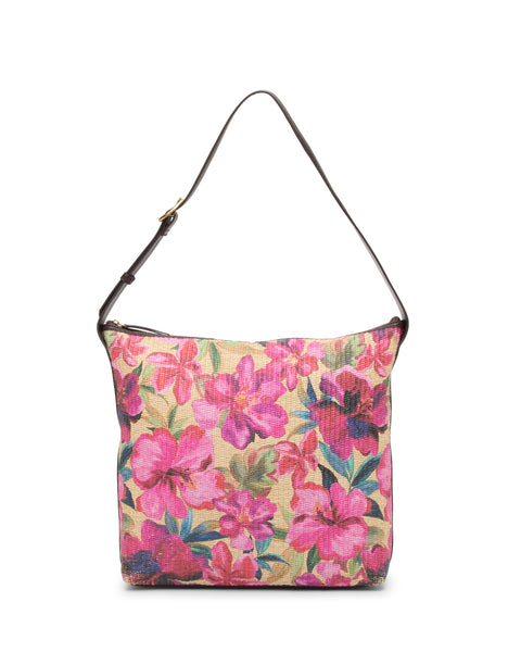 The Paula Shoulder Bag by Vince Camuto features a vibrant pink floral pattern with green leaves on beige canvas and a dark brown strap, making it a stylish choice for the beach.