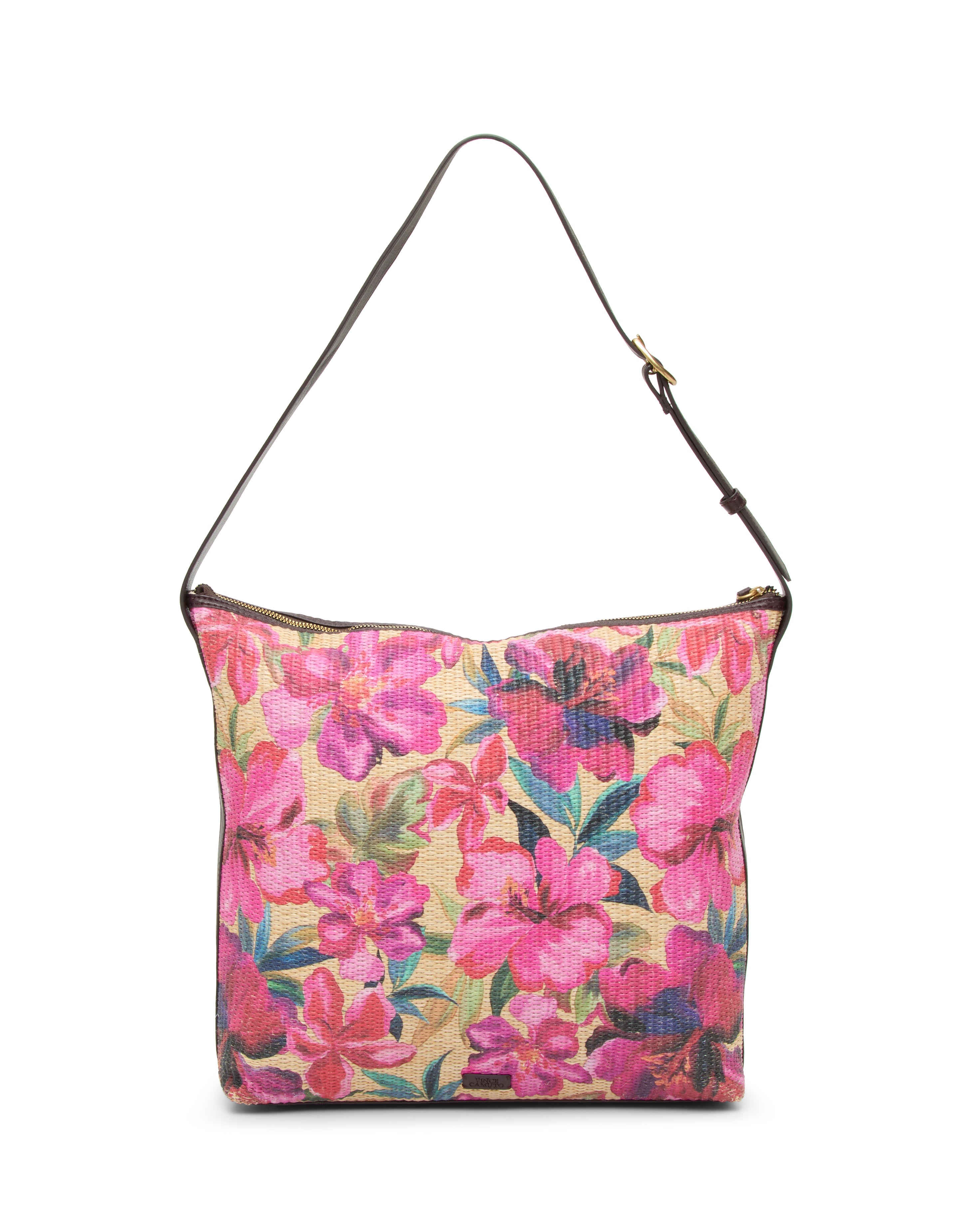 The Paula Shoulder Bag by Vince Camuto features a vibrant pink floral print on beige canvas with a single dark brown strap—an ideal accessory for carrying your summer essentials.