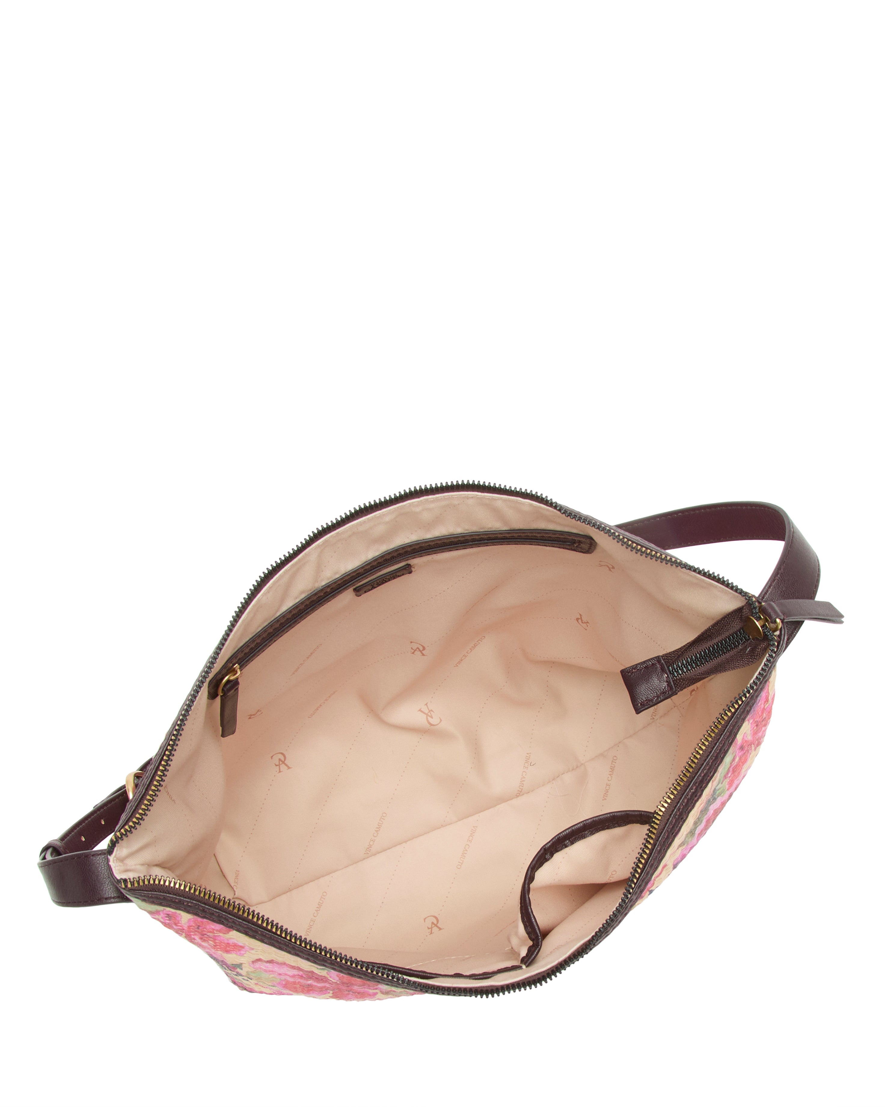 Top view of the Paula Shoulder Bag by Vince Camuto: canvas with a floral exterior, beige lining, brown leather strap, inner and zippered pockets—ideal for carrying your summer essentials.
