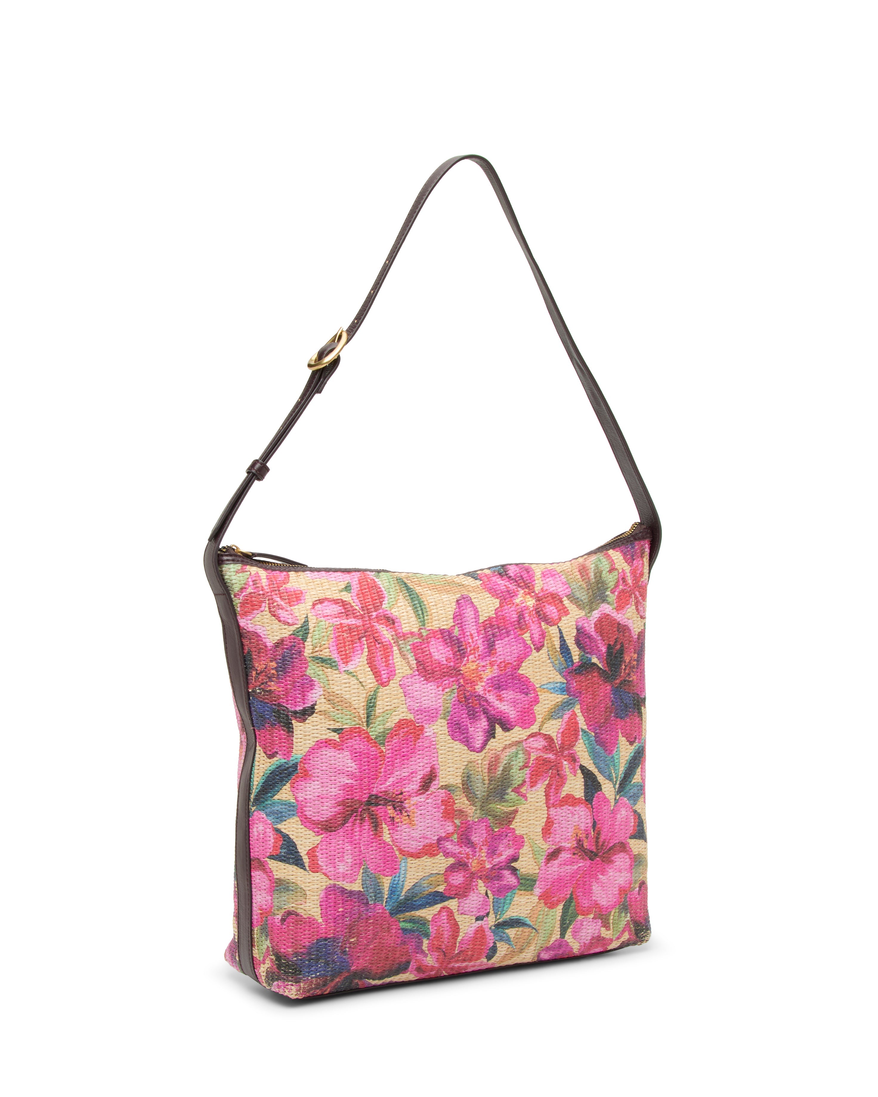 The Paula Shoulder Bag by Vince Camuto is a square canvas bag with a brown strap and a floral print of pink and purple flowers on beige—ideal for carrying your summer essentials.