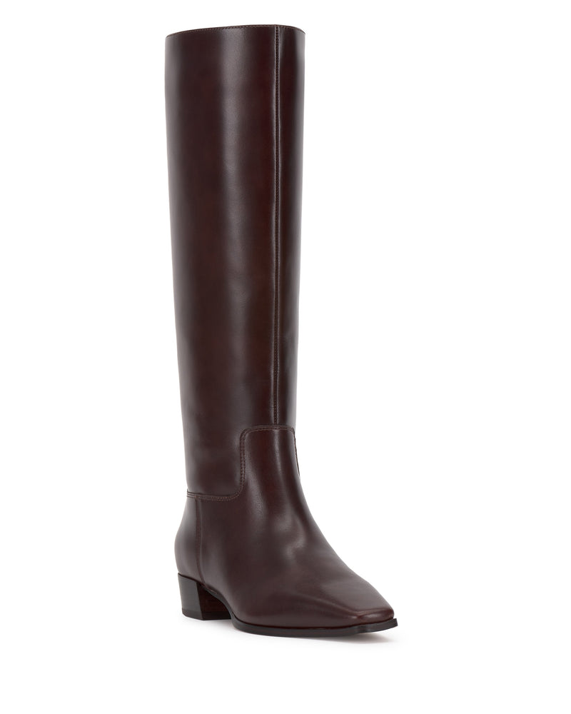 The Vince Camuto Pavla Narrow Calf Knee High Boot is a tall, dark brown leather boot with western styling, a low block heel, and a slightly pointed toe, displayed on a white background.