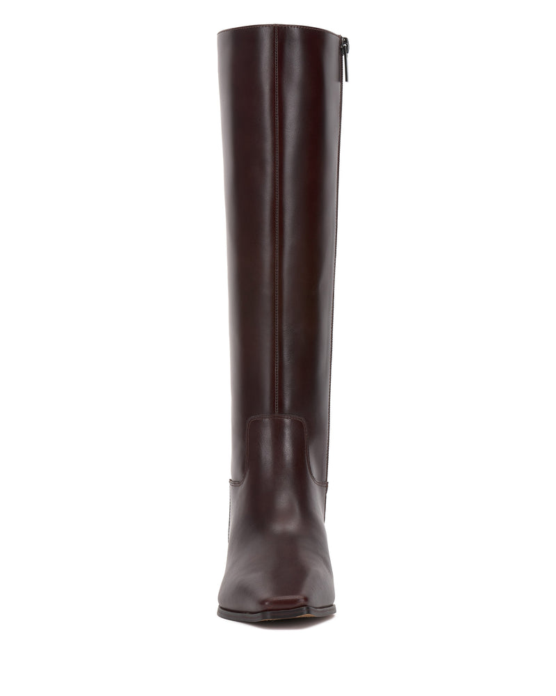 Front view of the Vince Camuto Pavla Narrow Calf Knee High Boot in dark brown, featuring a slightly squared toe, block heel, side zipper, and subtle western-inspired details.