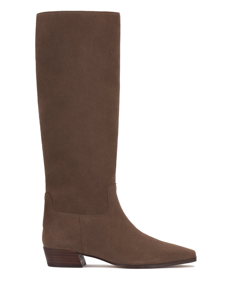 Shown in side profile against a white background, the Vince Camuto Pavla Narrow Calf Knee High Boot is a brown suede western boot with a pointed toe and low stacked wooden heel.