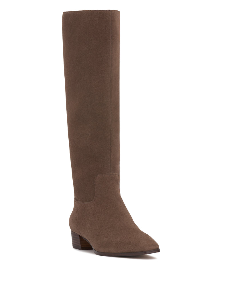The Pavla Knee High Boot by Vince Camuto is a brown, knee-high boot with a low block heel and pointed toe, inspired by classic western boots, shown against a white background.