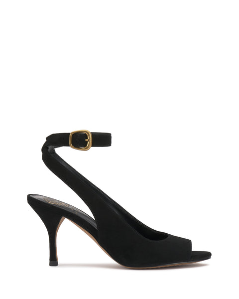 The Pavles Sandal by Vince Camuto is a black suede peep toe slingback with an ankle strap and gold buckle, featuring a slender mid-height heel. Displayed on a plain white background, it exudes timeless elegance.
