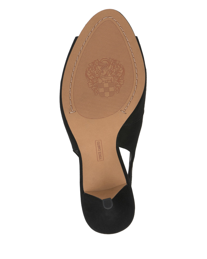 The image shows the sole of the Vince Camuto Pavles Sandal, a black heeled shoe. Its tan sole has a textured grip, an embossed crest near the ball of the foot, and "Made in Spain" stamped by the heel.