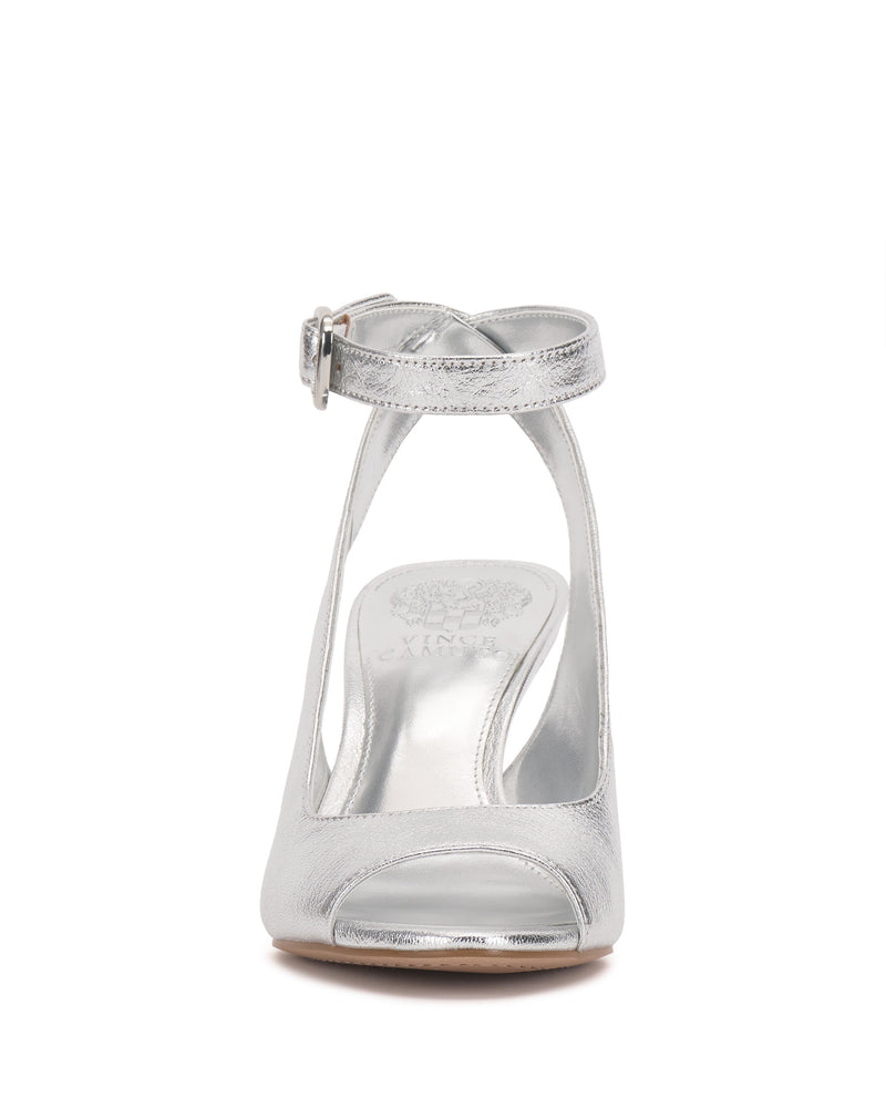 Front view of the Pavles Sandal by Vince Camuto: a shiny silver peep toe with a wrapped ankle strap, buckle, and elegant cutout side design on a smooth sole.