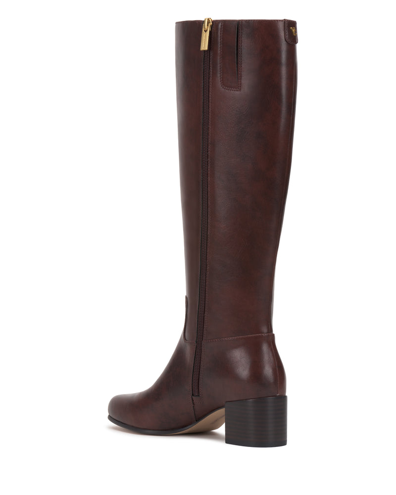 The Pazzla Wide Calf Knee High Boot by Vince Camuto is a single tall, brown leather boot featuring a low block heel, an inner side zipper, and a rounded toe, displayed from a side angle on a white background.