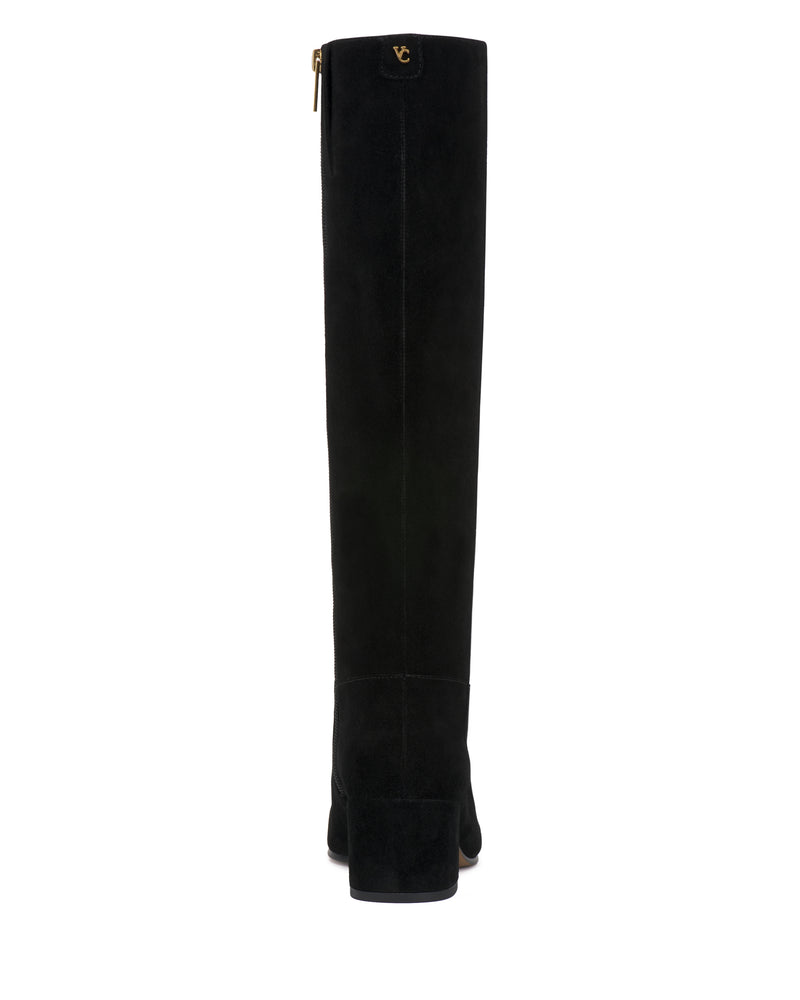 The Vince Camuto Pazzla Extra Wide Calf Knee High Boot is shown in black suede from the back, featuring a low block heel and a small gold emblem near the top.