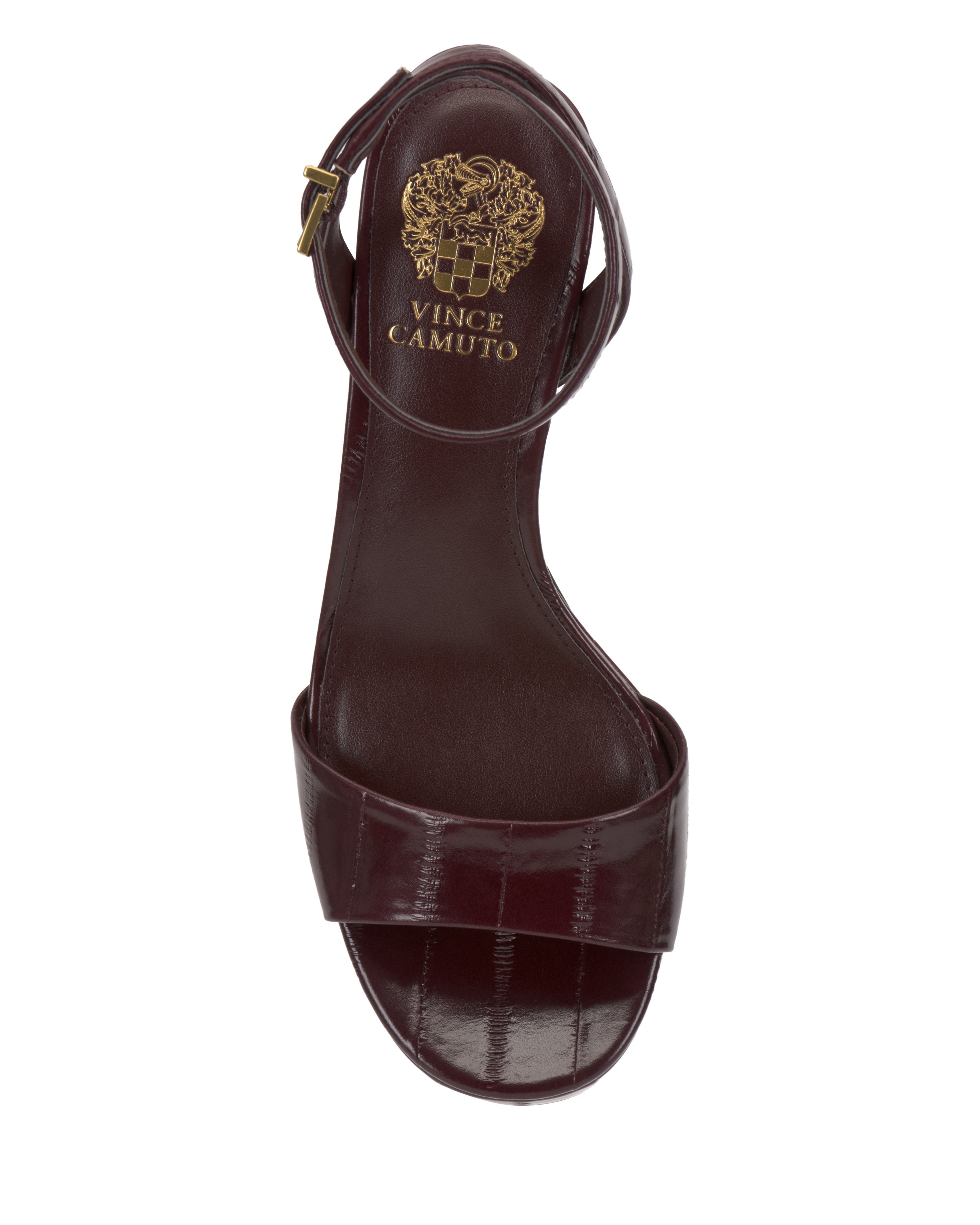 A top view of the Vince Camuto Pendreya Platform Sandal in dark burgundy shows its block heel, ankle strap with gold buckle, and the brand's gold logo printed on the insole, highlighting its retro style elegance.