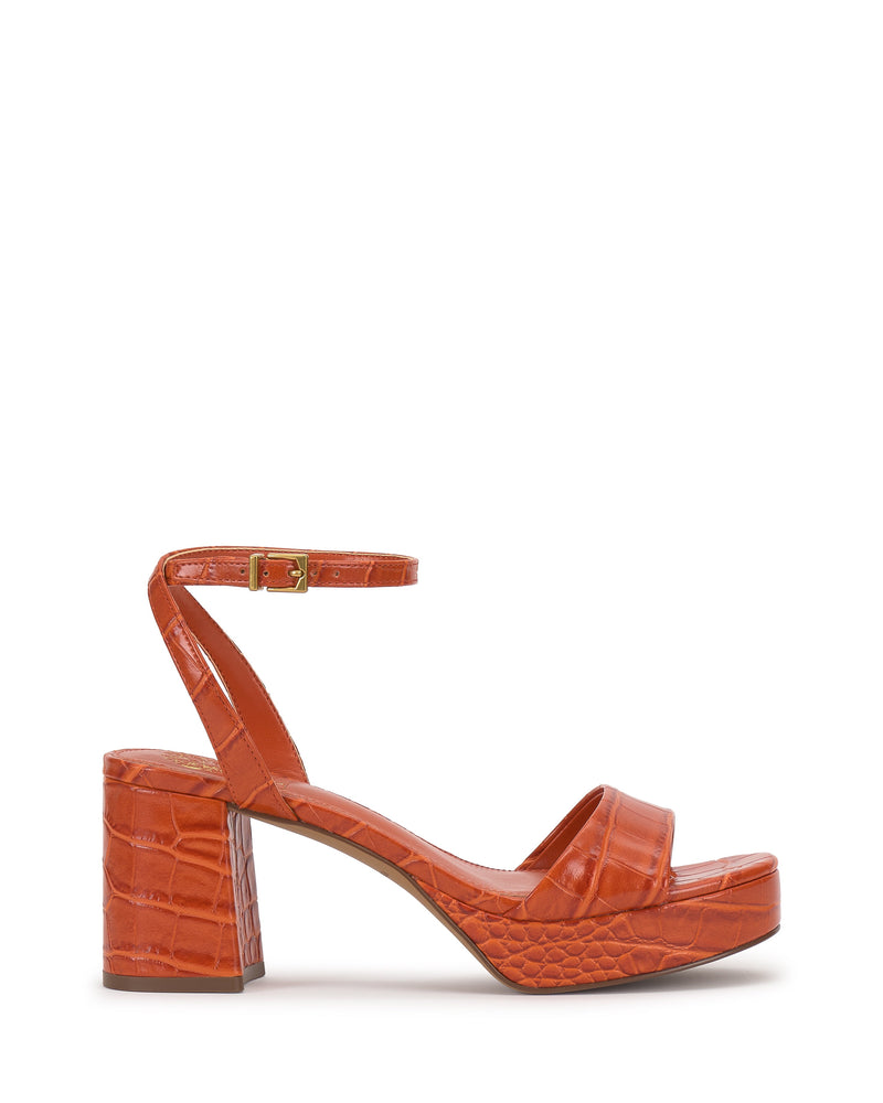 The Vince Camuto Pendreya Platform Sandal is an orange, croc-embossed shoe with a retro block heel, ankle strap and buckle, open toe, and platform sole, shown against a plain white background.