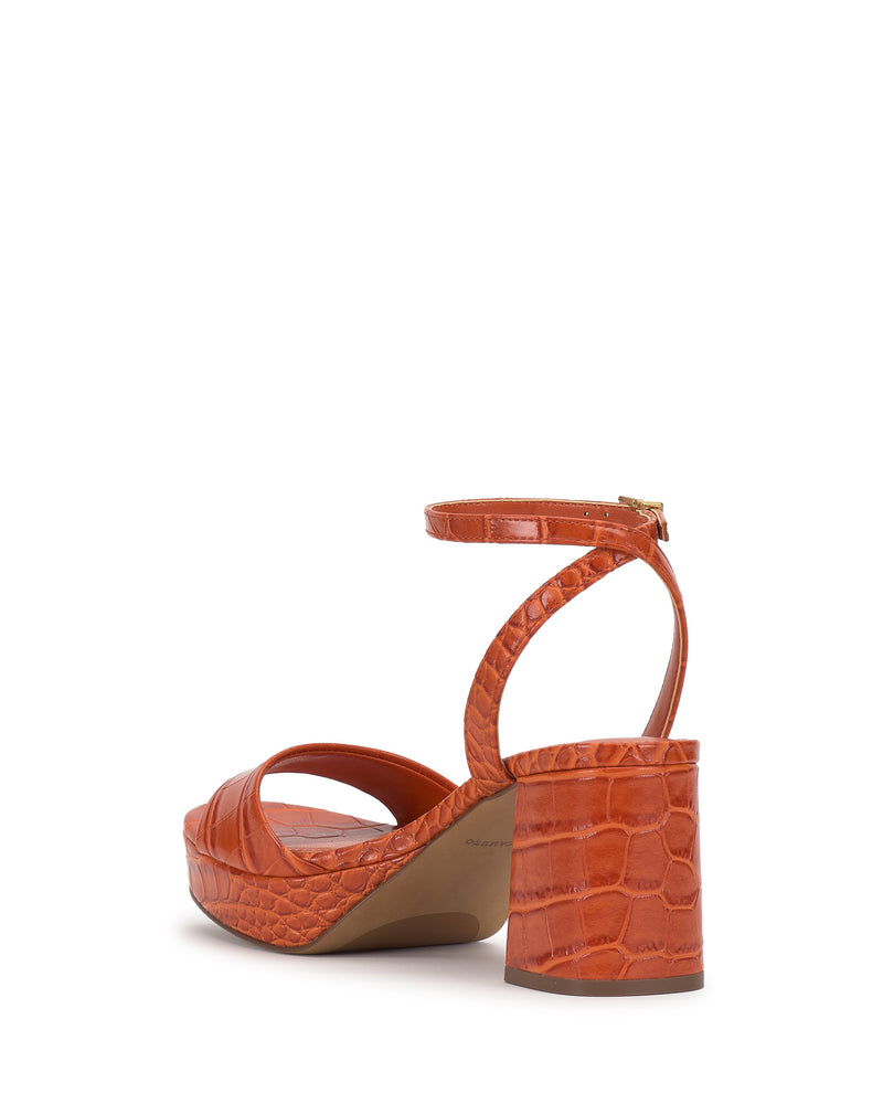 The Vince Camuto Pendreya Platform Sandal features a stylish orange design with a retro crocodile-patterned block heel, ankle strap, thick platform sole, and a gold buckle at the back for added flair.