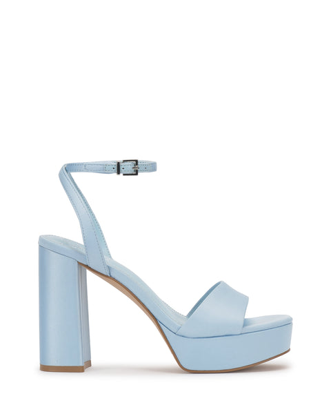 The Vince Camuto Pendry Platform Sandal features light blue color, a thick block heel, wide front strap, and an ankle strap with buckle for a retro vibe, shown in side profile against a white background.