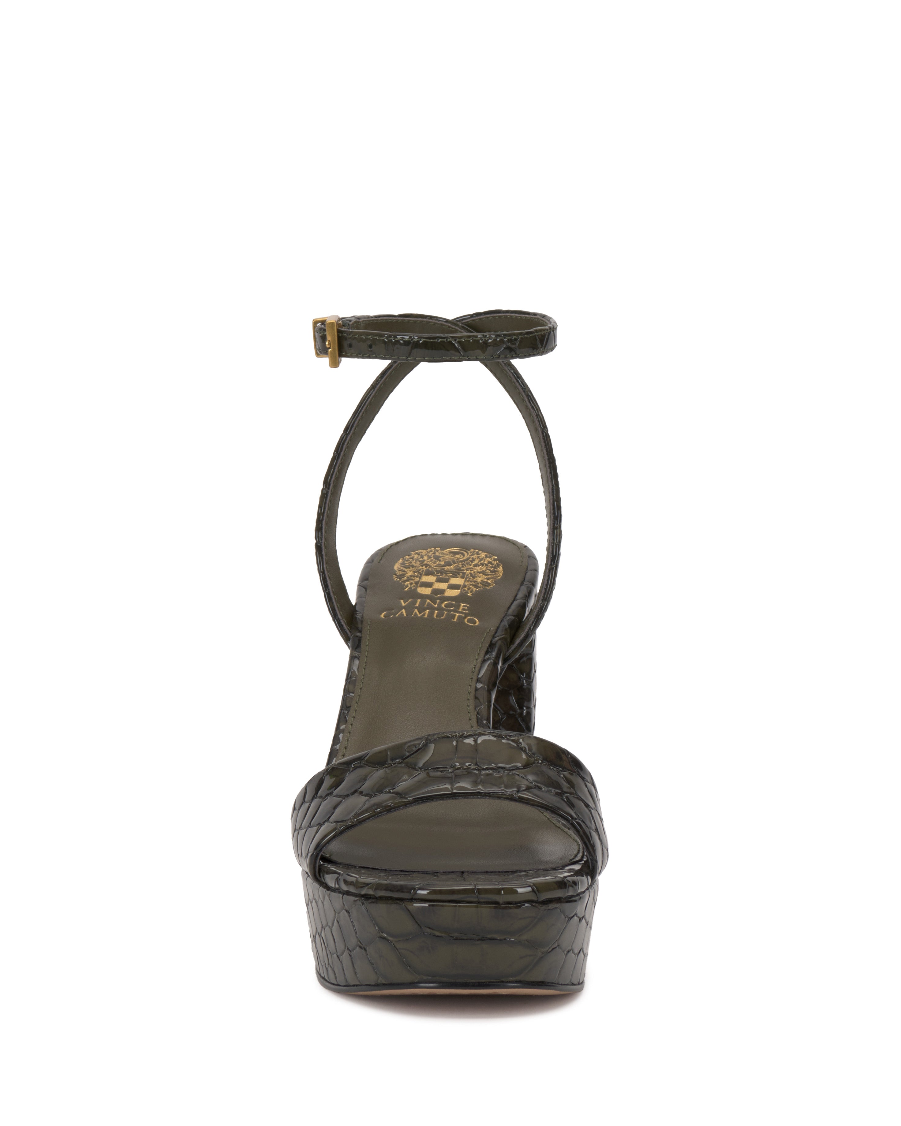 Front view of the Pendry Platform Sandal by Vince Camuto, featuring dark green crocodile-embossed leather, an ankle strap with gold buckle, chunky ‘70s-inspired heel, bold silhouette, and gold branding on the insole.