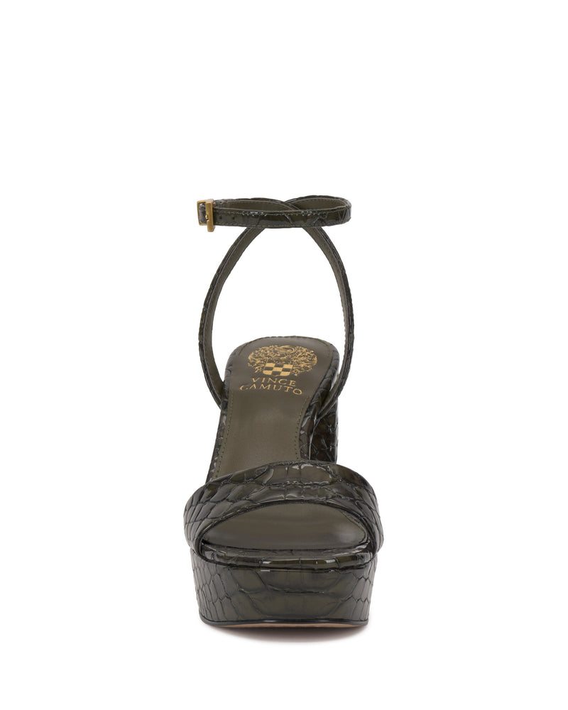 Front view of the Pendry Platform Sandal by Vince Camuto, featuring dark green crocodile-embossed leather, an ankle strap with gold buckle, chunky ‘70s-inspired heel, bold silhouette, and gold branding on the insole.