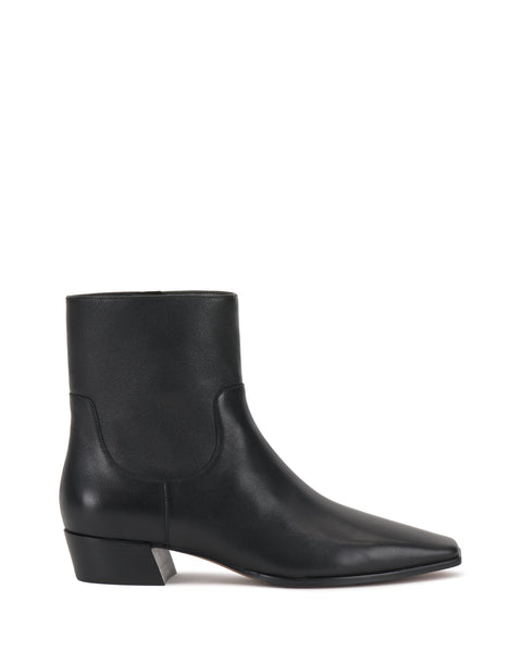 The Vince Camuto Pertula Bootie is a black leather ankle bootie with a pointed toe, low block heel, and smooth finish, displayed in a side view against a white background, showcasing the brand’s signature sleek design.