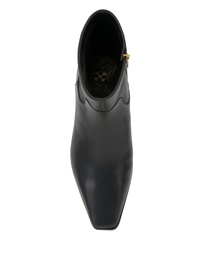 Top view of the Pertula Bootie by Vince Camuto in black leather, showcasing a squared toe and convenient side zipper. The patterned insole displays gold Vince Camuto text and logo. This pointed toe ankle bootie is elevated by a chic block heel for a sophisticated finish.