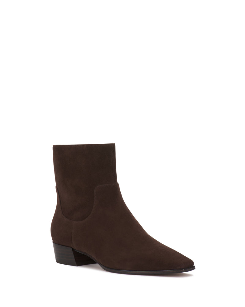 The Pertula Bootie by Vince Camuto is a dark brown suede ankle boot featuring a low block heel and pointed toe, showcased against a plain white background.
