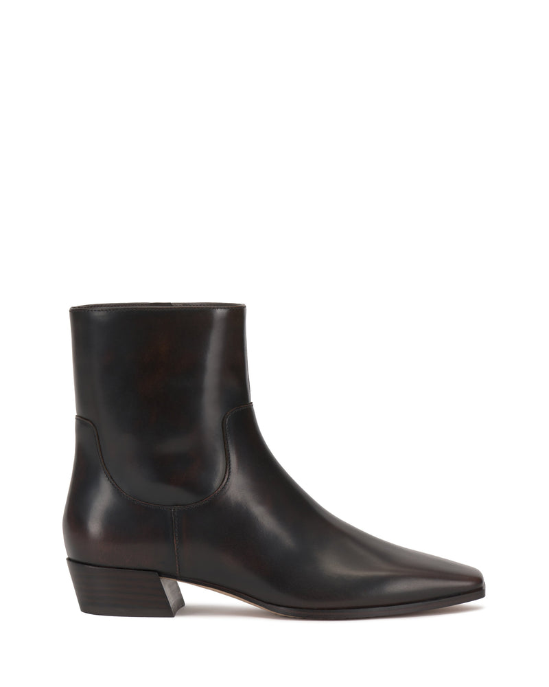 A side view of the Vince Camuto Pertula Bootie in dark brown leather, featuring a pointed toe and a low, angled block heel, displayed on a white background.