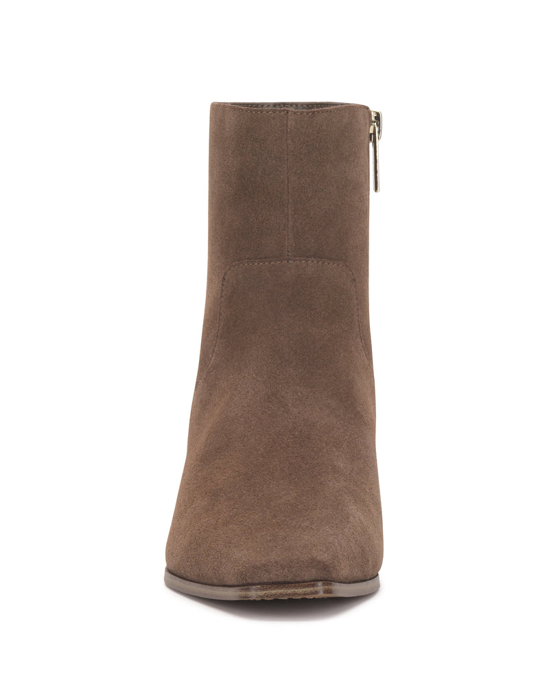 Front view of the Vince Camuto Pertula Bootie, a pointed toe ankle bootie crafted from brown suede, featuring a side zipper and a stylish block heel, shown against a white background.