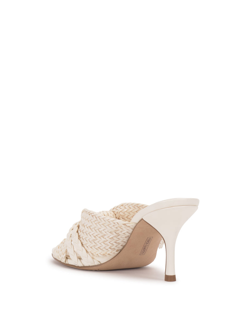The Vince Camuto Pheya Mule, a single white heeled shoe with a woven design and braided front strap, is shown at a slight rear angle on a plain white background.